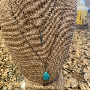 2 strand silver tone necklace with turquoise colored pendant.